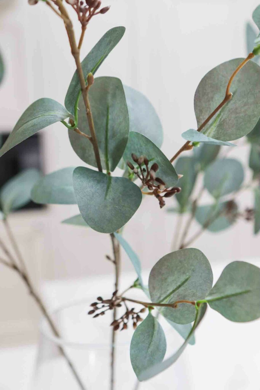 three grey faux eucalyptus stems