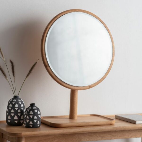 light brown round mirror on stand