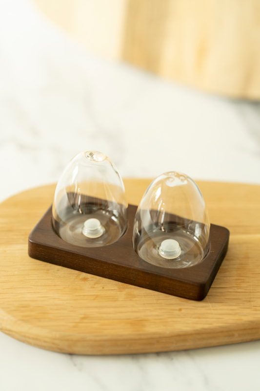 glass salt and pepper shaker with wooden acacia board