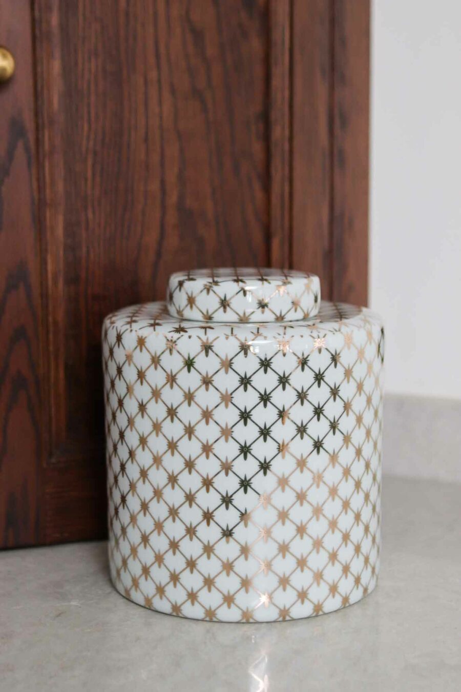 large gold and white patterned tea jar