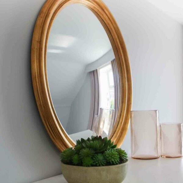 large gold framed convex mirror