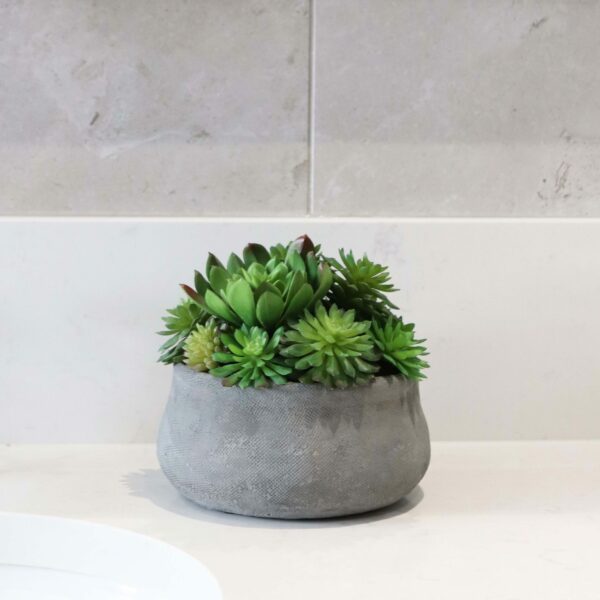 small faux mixed succulent in small grey stone bowl
